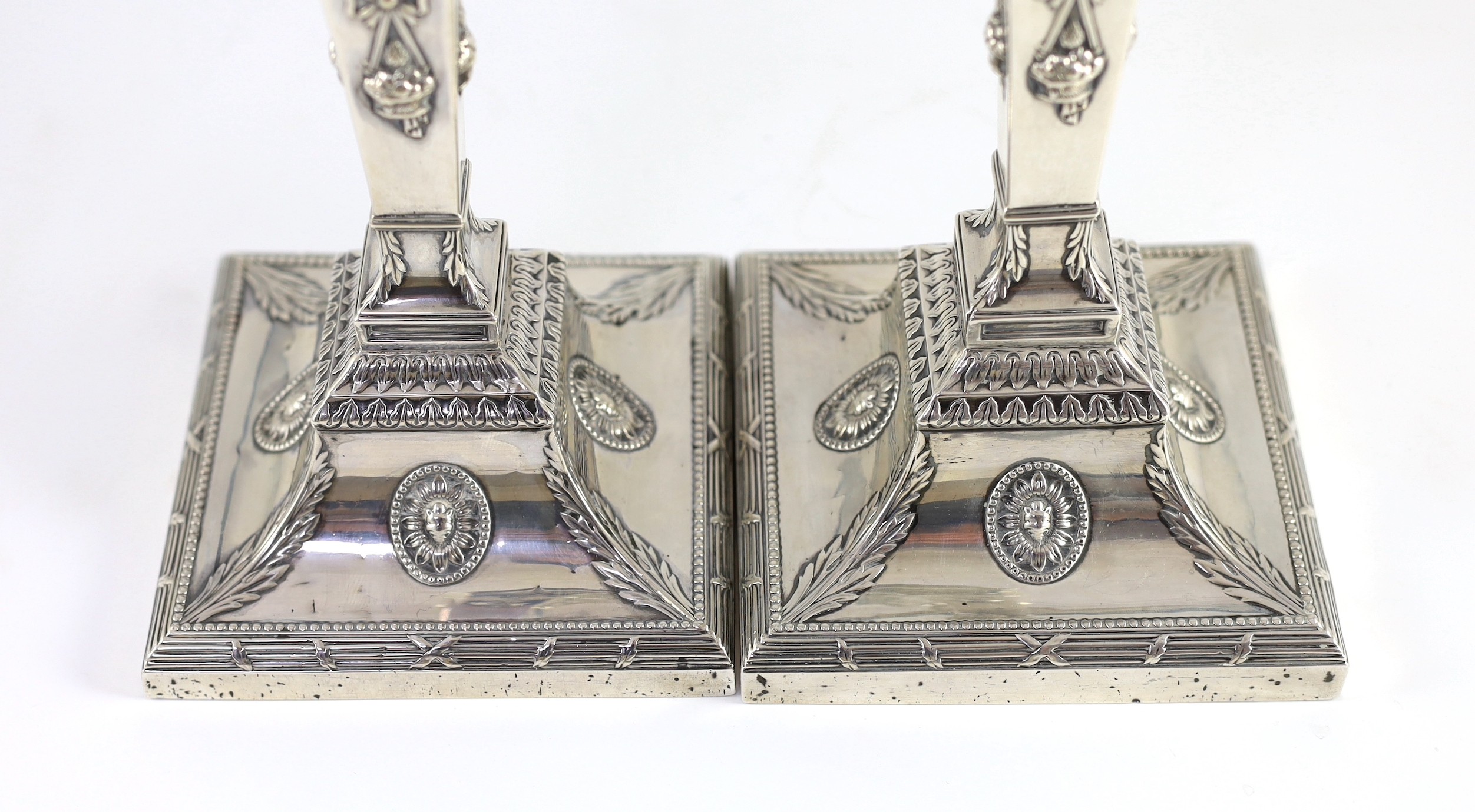 An ornate pair of late Victorian silver candlesticks by Mappin Bros.